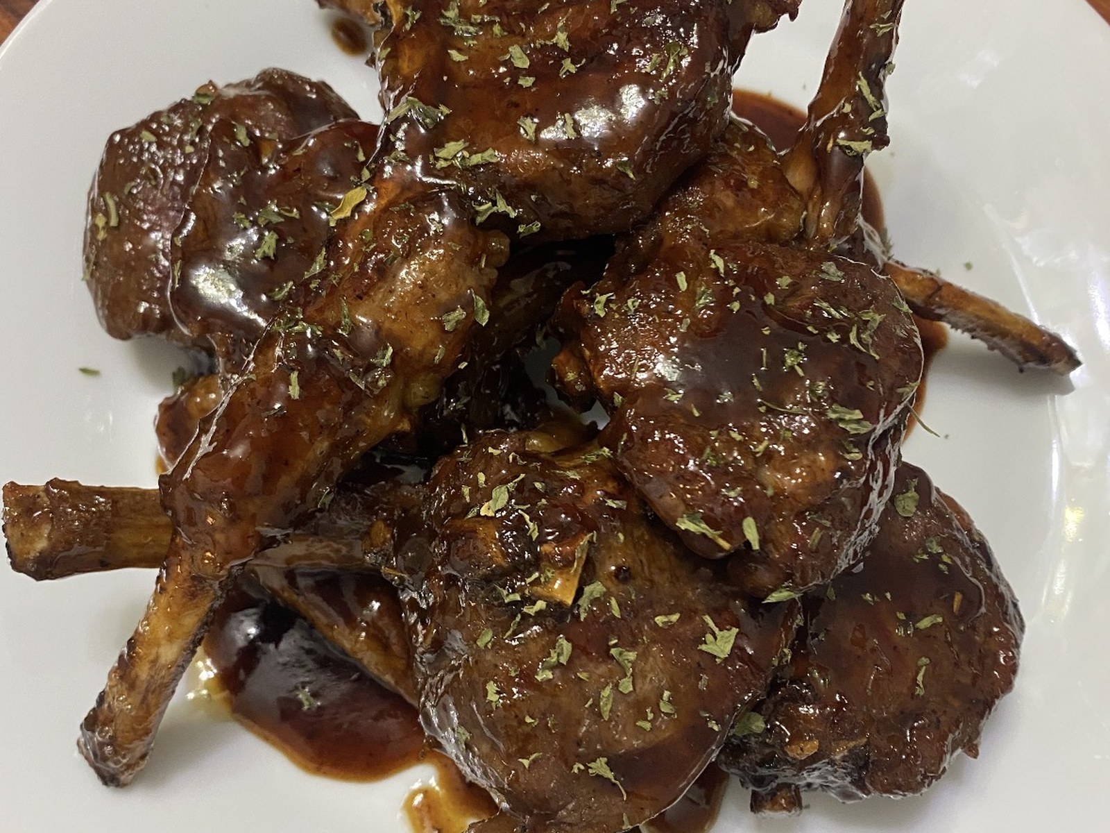 Grilled lamb chops finished with brown gravy and herbs